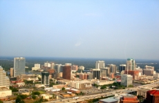 A shot depicting downtown Orlando, Florida featuring the cityscape, a busy roadway, and the ocean.