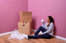 woman sitting on the floor of her apartment