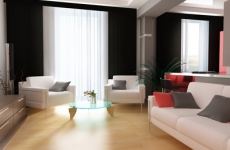 A modern looking living room with light wood floors and white leather seating. 