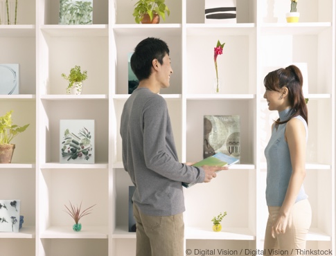 Young Couple redecorating their shelves