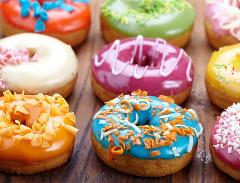Array of vibrantly frosted donuts