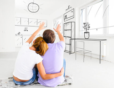 Couple looking at unfurnished apartment, imagining all of the possibilities