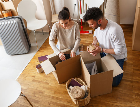 Young couple unpacking after move