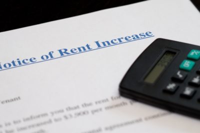 rent increase notice on desk with calculator