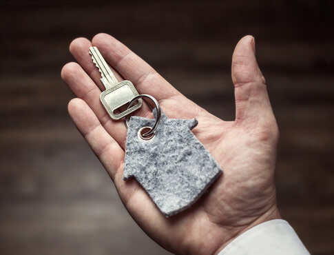Hand holding apartment key
