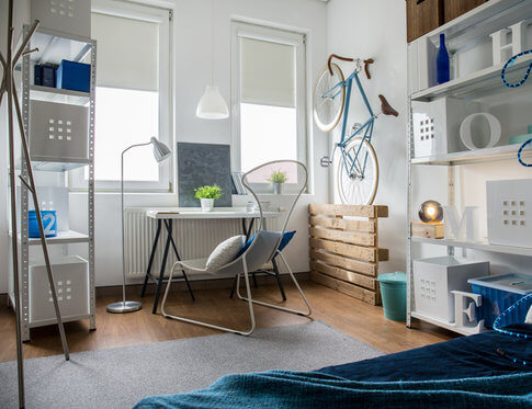Small studio apartment decorating with blue and gray