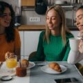 Three female roommates having breakfast together.