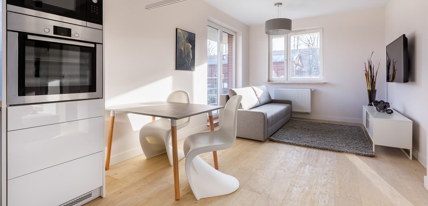 Small modern apartment with gray and white theme.