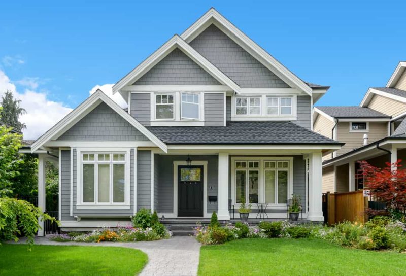 Gray home with white trim in suburban neighborhood.