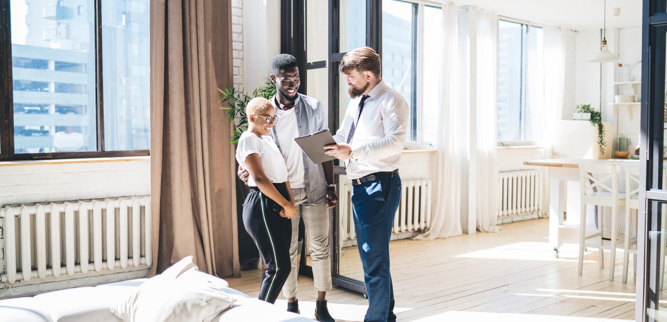 Couple reviewing rental agreement with realtor.