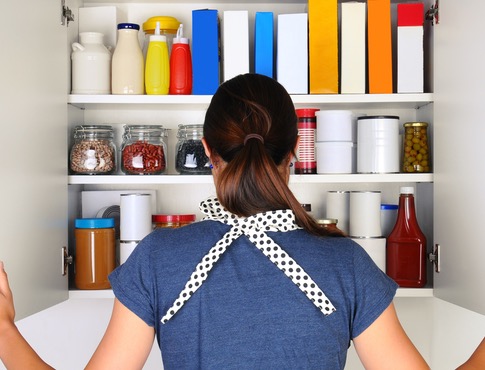 Woman looking inside an open pantry