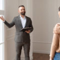 Young couple with leasing agent looking at what is included in a move-in ready apartment.