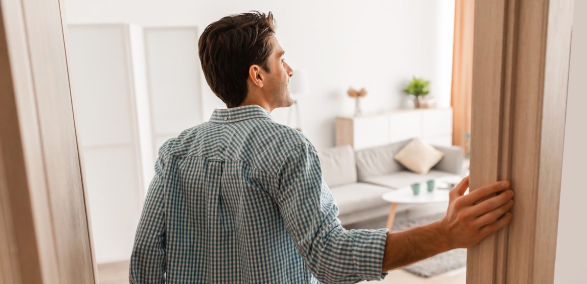Man finally finds apartment after wondering why it is so hard to find an apartment and now he is smiling and looking in