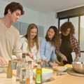co-living mates enjoying cooking together at home