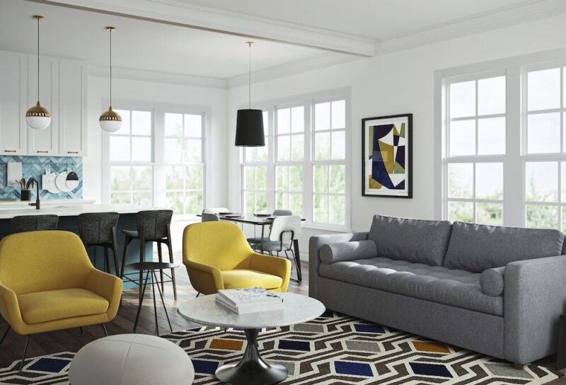 A bright apartment with grey furniture and yellow accents.