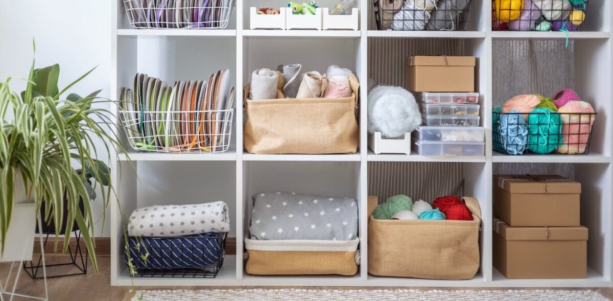 Small, square shelves store yarn and other art supplies.