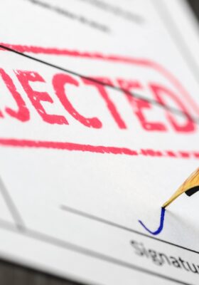 Form close up, fountain pen and rejected stamped on a document., resulting in applicant wondering why would an apartment reject an applicant and what to do after being rejected for an apartment.